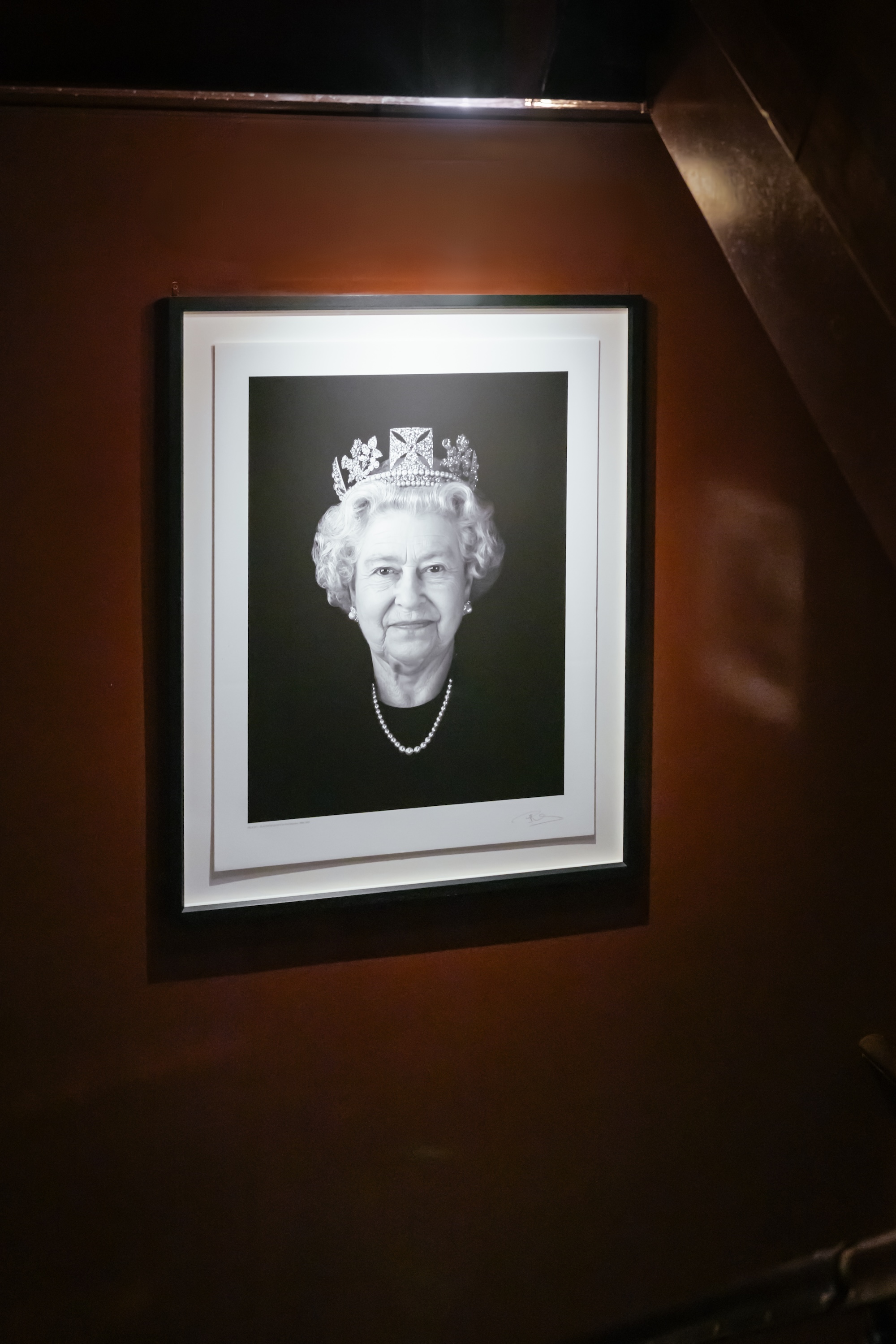 Portrait of Queen Elizabeth in the stairwell to the grill at The Devonshire.